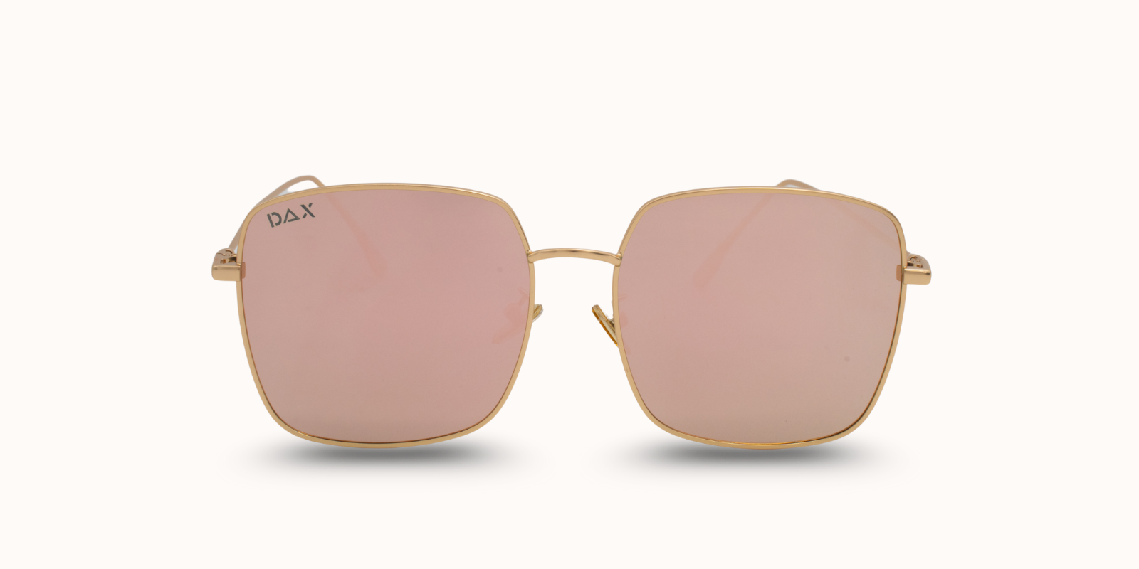 Sunglasses with gold frame and pink lenses on a white background