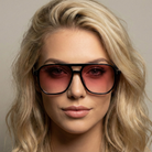 Woman wearing large sunglasses with a neutral background