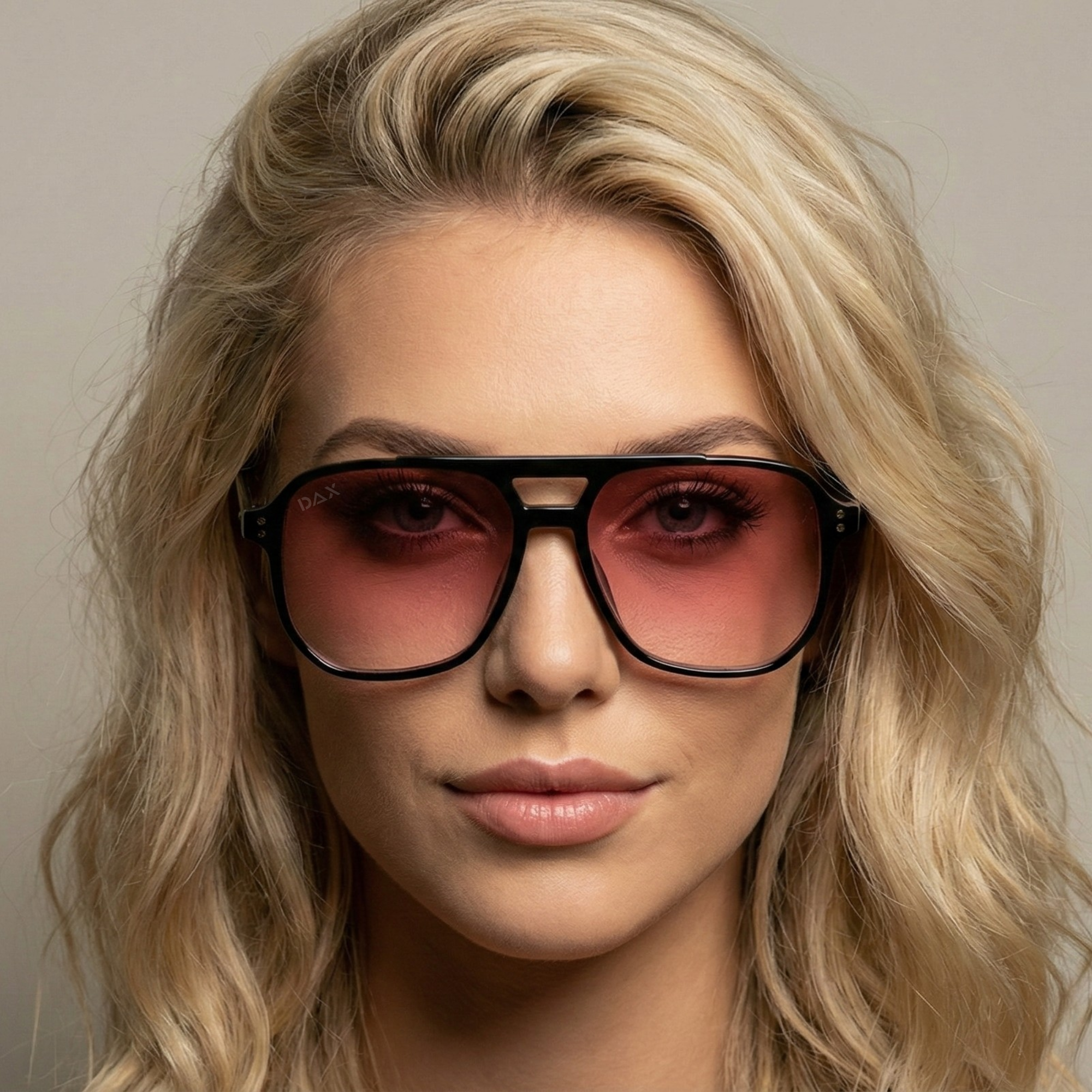 Woman wearing large sunglasses with a neutral background
