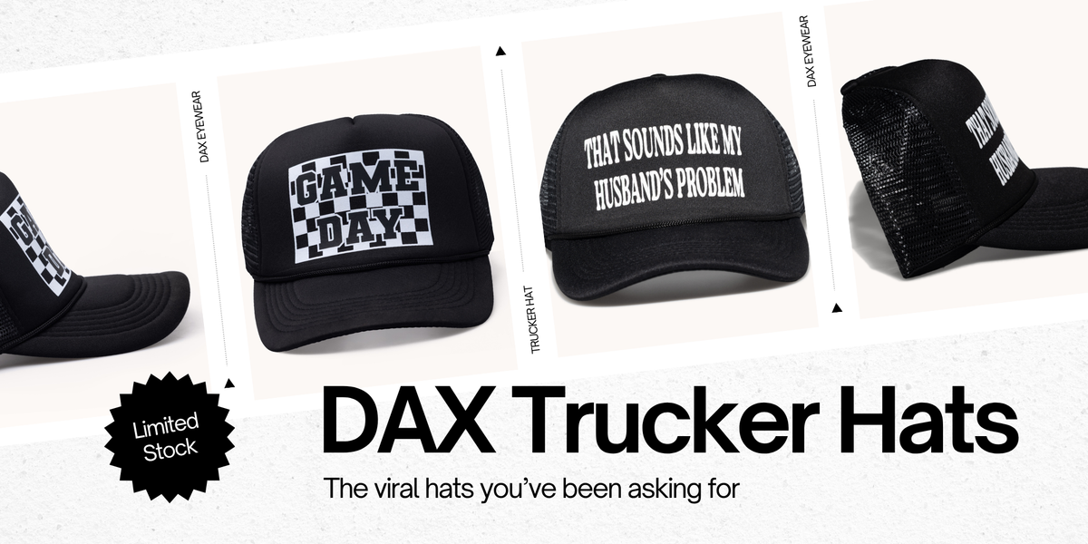 A promotional collage showing multiple black trucker hats with white text and graphics. The center hat reads 'GAME DAY' over a checkerboard pattern, and another hat reads 'THAT SOUNDS LIKE MY HUSBAND'S PROBLEM.