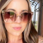 Woman wearing DAX sunglasses with a blurred outdoor background
